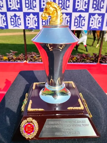 The H.B. Gundappa Gowda Memorial Trophy, a sleek silver trophy with a golden horse finial.