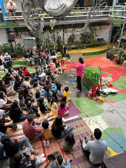 I can turn any space, big or small, into a theatre of imagination. Here I am at a school event, sharing a story with over a hundred families. It brings me so much joy to see both kids and parents completely absorbed in the performance together.