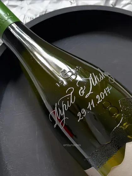 A personalized wine bottle, engraved with names and a wedding date. I've lost count of how many bottles I've customized, but with each one, I try to refine my skill and make it better than the last.