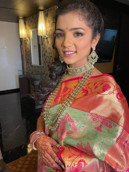 The complete engagement look. The bride's makeup is soft and glowing, letting the beautiful saree and jewelry take center stage.