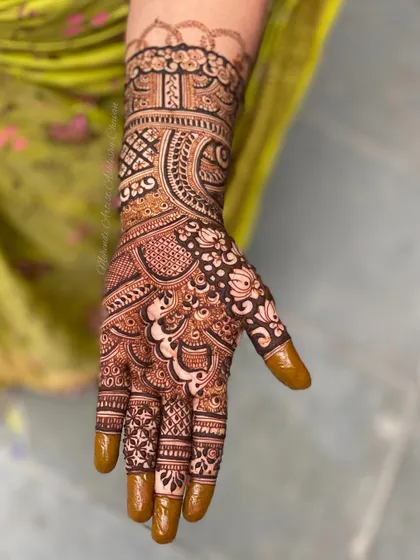 A single hand from a full-coverage design. This close-up shows the detail and precision in the line work and filling.