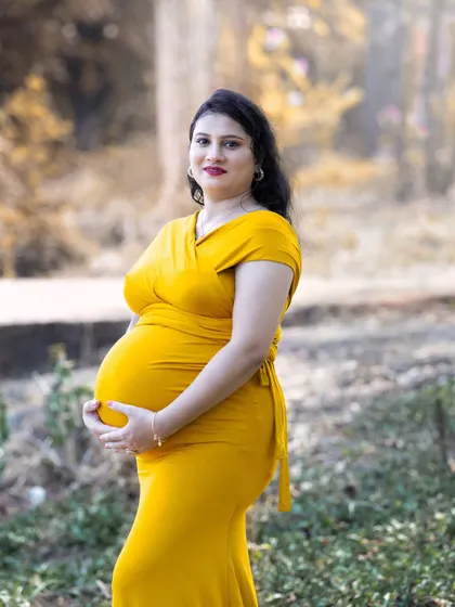 My photography style often uses the warm, golden glow of natural light to create soft and intimate portraits. This medium shot focuses on the mother's happy expression, capturing a quiet moment of connection in a beautiful, naturally lit setting.