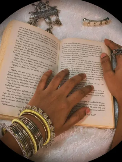 An artistic shot showing the yellow and silver bangles, along with other pieces from the collection like the finger ring and saree pin.