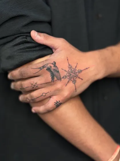 A stylish shot of the client's hand tattoo, with his hand resting on his arm.