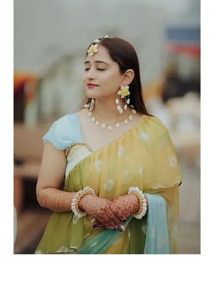 A beautiful portrait of the bride at her Haldi ceremony. The soft focus and her calm expression create a dreamy and elegant image.