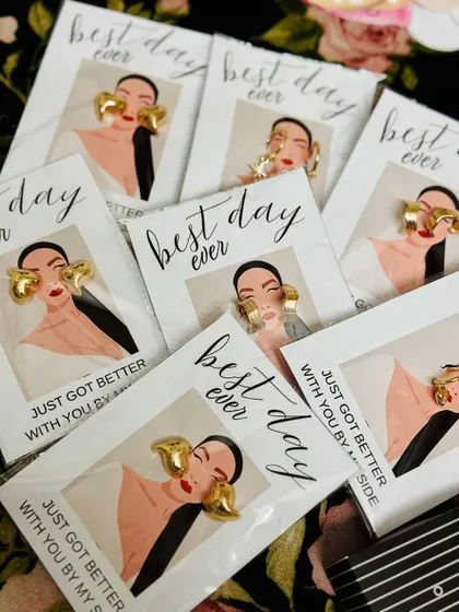 A closer look at the stylish earring favors included in my bridesmaid hampers. The "Best day ever just got better with you by my side" packaging adds a thoughtful and personal touch.