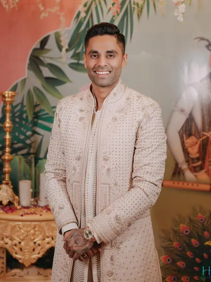 Suryakumar Yadav in a stunning embroidered sherwani by Tarun Tahiliani. The subtle color palette and detailed craftsmanship make this a sophisticated choice for any grand occasion.