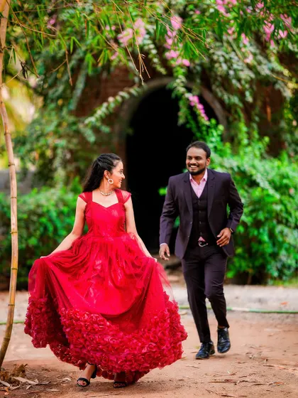 A candid and happy moment as the couple walks through a natural, rustic path.
