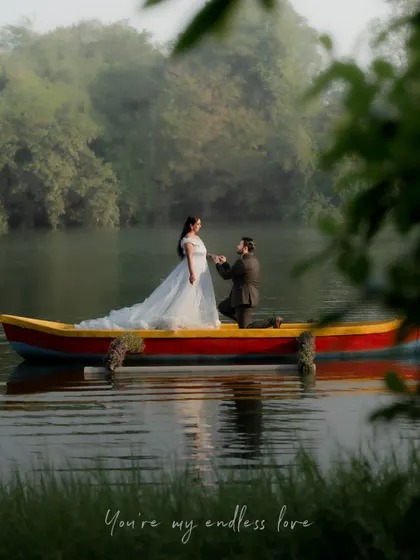 A wide shot of the couple in a boat, surrounded by the morning mist on the lake. This image captures a sense of peace and endless love.