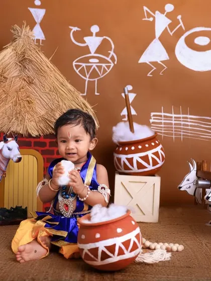 It's all about the butter! This playful shot shows our little Krishna enjoying a pot of 'makhan', a classic and fun moment to capture during a Janmashtami shoot.