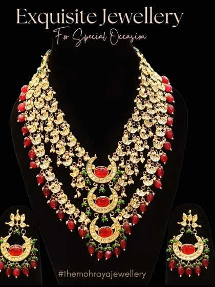 An exquisite multi-layered necklace with red stones and crescent-shaped motifs, perfect for a grand bridal entry. This piece is a beautiful example of traditional craftsmanship.