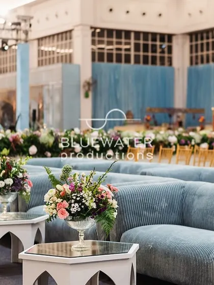 The soft blue lounge furniture provided a comfortable viewing area for guests, looking towards the main stage.