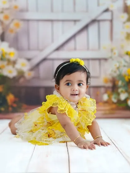 Crawling towards the next adventure! This milestone photo captures a baby on the move against a beautiful floral backdrop.