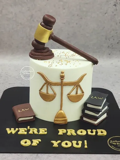 A proud moment celebrated with a law-themed cake. This design includes a judge's gavel, the scales of justice, and a stack of law books.