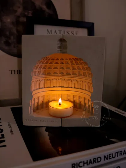 The Pantheon tealight holder, shown here illuminating a stack of books. It's a perfect example of how my sculptures can be both artistic and functional.