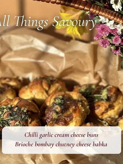 A basket of my savory bakes, including chilli garlic cream cheese buns and brioche Bombay chutney cheese babka, ready for a bake sale.