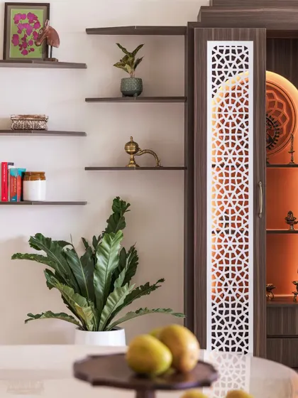 This puja unit features a captivating arch design and jali-cut doors. The open ledges next to it provide a perfect platform to showcase cherished knick-knacks and religious artifacts.