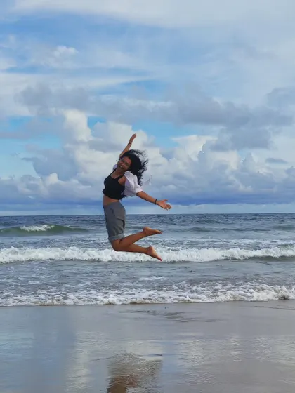 An energetic jump on the beach, capturing a feeling of freedom. This dynamic lifestyle shot is perfect for activewear, travel, or any brand with a youthful spirit.