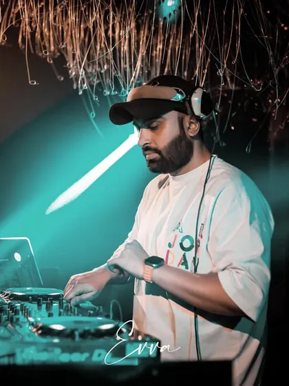 A candid shot of me working the turntables. The right track at the right time can change the entire mood of a party, and that's the craft I've dedicated myself to.