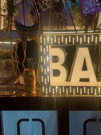 A close-up of the illuminated 'BAR' sign from a custom event bar setup. Details like this add a professional and fun touch to any celebration, making the beverage station a standout feature of the event.
