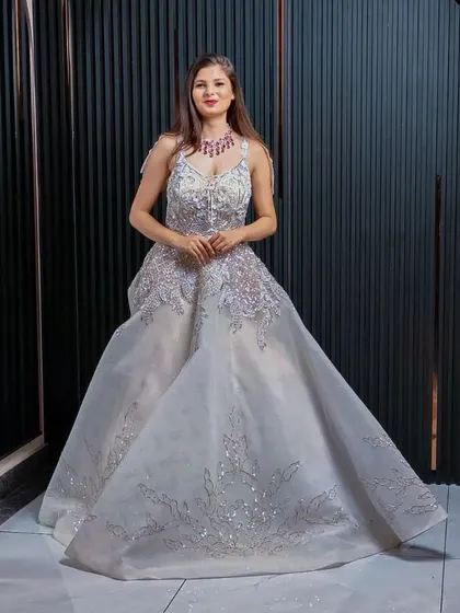 A full view of the magnificent silver gown, showcasing its grand silhouette. This is an ideal rental for making an unforgettable entrance at any formal event.