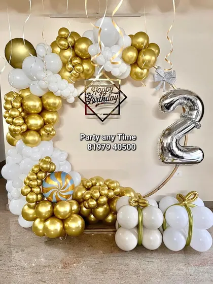 A beautiful gold and white balloon arrangement for a 2nd birthday party.