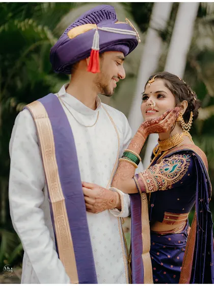 A loving gaze between the bride and groom. Their traditional Maharashtrian attire and the genuine emotion make this a timeless portrait.