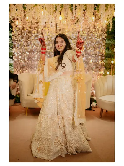 A high-energy shot of the bride dancing with joy. Her expression and pose are full of life, capturing the celebratory spirit of the wedding.