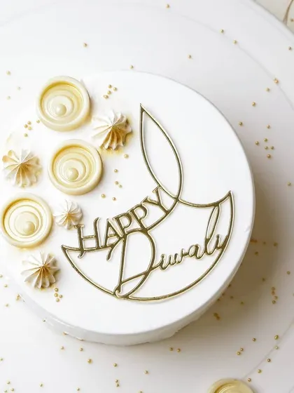 Wishing everyone a Happy Diwali with this elegant diya topper. I designed this piece in a minimalist line-art style, finished in mirror gold acrylic to add a modern yet festive touch to this beautiful all-white cake by Truffles Bangalore.