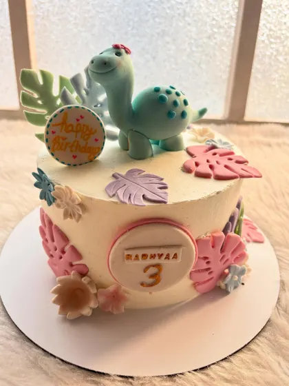 A pastel dinosaur cake for a little girl's third birthday. I used soft pink and purple leaves to give this popular theme a unique and gentle feel.