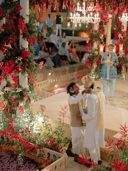 A moment of joy during the Jaimala ceremony. The entire space was filled with red flowers, from the garlands on the pillars to the petals on the ground, creating an immersive and celebratory atmosphere for Kahran and Gourav.