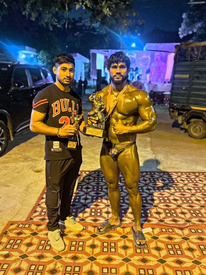 After securing two gold medals, posing with my trophy and a teammate. The work is hard, but the victory is sweet.