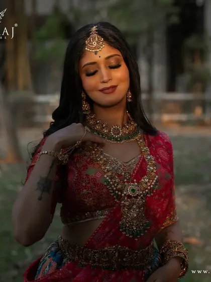 A close-up portrait, focusing on the intricate details of the blouse and the bride's expression.