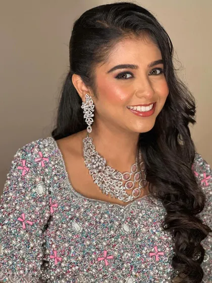 A smiling portrait showcasing the beautiful, contemporary necklace and earring set, ideal for modern ethnic wear.