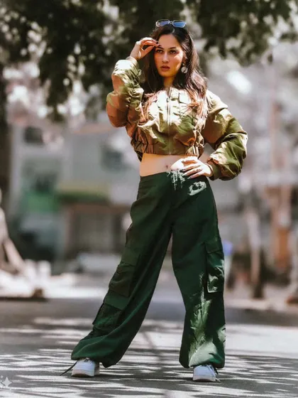 A full-length shot with a strong, grounded pose. This image is great for showcasing the entire outfit in a real-world urban environment.