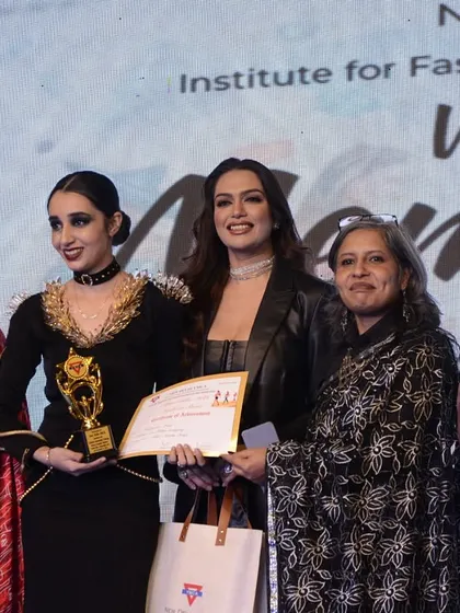 A student designer receives the 'Best Design Collection' award for her avant-garde creations.