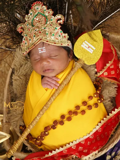 A full view of the baby as little Lord Murugan, looking absolutely serene and divine. These are truly special portraits for devout families.