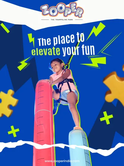 This is the place to elevate your fun. A young climber carefully makes her way up the inflatable pillars, a unique and exciting climbing challenge.