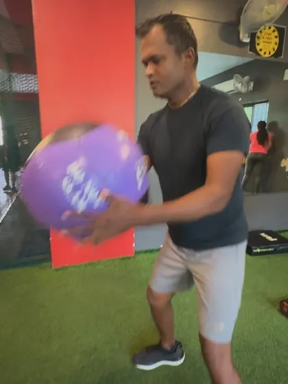 A client prepares to perform a rotational medicine ball throw, a great exercise for developing core power.