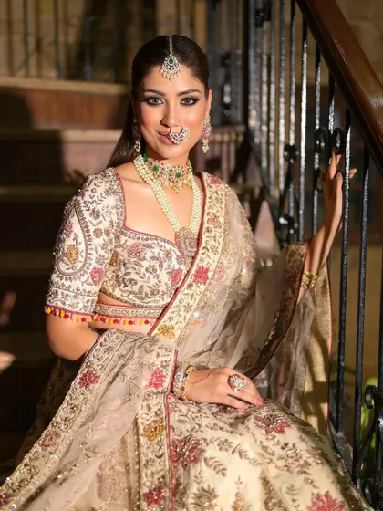 The bride's happy and confident expression is the centerpiece of this shot. Her makeup is flawless, enhancing her natural beauty and completing her elegant look.