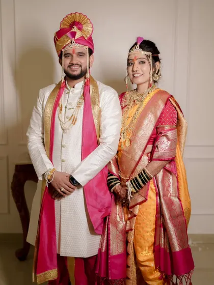 A formal portrait showcasing the complete Maharashtrian bridal attire. The makeup is expertly balanced with the heavy jewelry and vibrant saree.