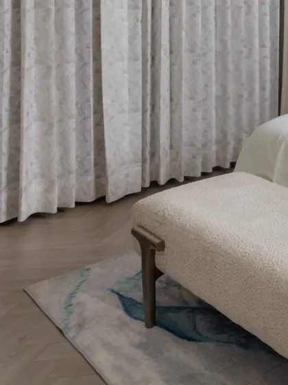 A closer look at the details in the daughter's bedroom. The custom bedside table with its fluted design, the hanging pendant light, and the elegant study nook with a wooden slatted wall all contribute to a space that is both youthful and sophisticated.