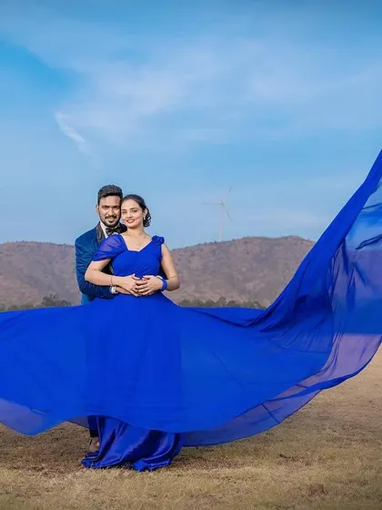 A duplicate image of the epic blue trail gown shot.