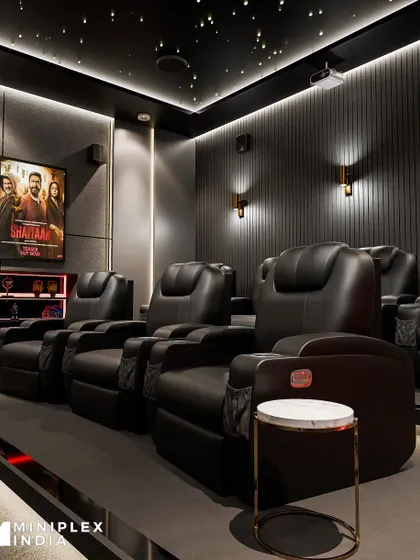 The details make the design. Here you can see the custom movie poster lightboxes and the quilted pattern on the recliner seats, adding a personalized and luxurious touch to the 'Celestial Escape' room.