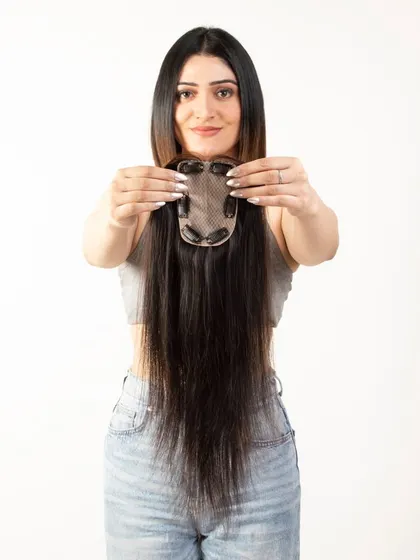 A model displaying the clip side of a long hair topper, detailing the construction for customer information.