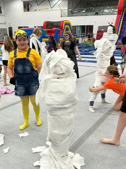 It's a wrap! Our "Make-A-Mummy" contest during a Halloween-themed Friday Fun Night is just one example of the creative and hilarious games we organize to keep every kid engaged and laughing.