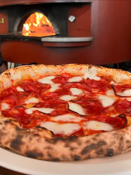 Our pepperoni pizza, fresh from the wood-fired oven. The heat brings out all the amazing flavours.