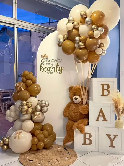 "It's twins, we can bearly wait!" A perfect theme for a twin baby shower, this setup uses a neutral brown and white palette with two teddy bears.