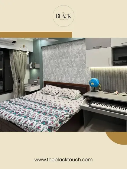 This bedroom combines functionality with style, featuring a built-in desk and keyboard next to the bed. The design is perfect for a multi-purpose room, offering a comfortable space for both rest and work.