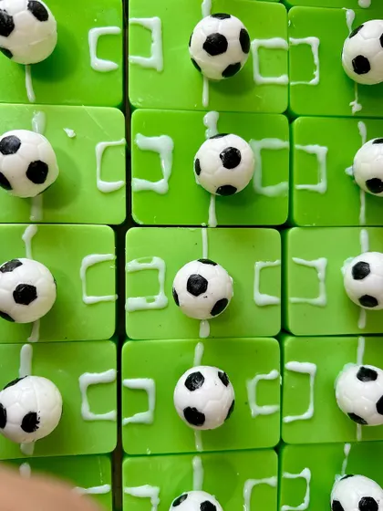 Goal! A close-up of my custom football-themed soaps, complete with a green field, goalposts, and a mini football. This shows how I can turn any hobby or theme into a unique, handcrafted soap for parties and gifts.